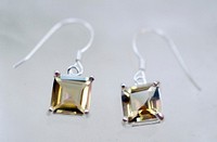 Shiny square shaped synthetic earring. Free public domain CC0 image.