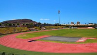 Empty running track and field during daytime. Free public domain CC0 photo.