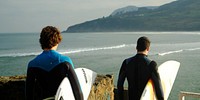 Free people carrying their surfboard by the sea photo, public domain sport CC0 image.