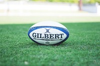 Gilbert Rugby ball on grass, location unknown, date unknown. View public domain image source here