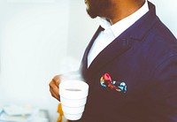 Free business man holding hot coffee in public domain CC0 photo.