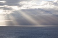 Free calm sea with beam of light coming out from the cloud image, public domain CC0 photo.