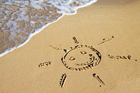 Smiley face drawing on sandy beach, free public domain CC0 photo.