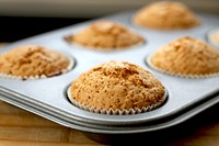 Frshly baked muffin in baking tray. Free public domain CC0 photo.