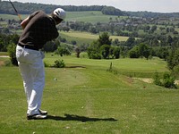 Free man playing golf on sunny day photo, public domain CC0 image.
