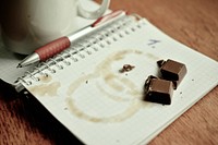 Free chocolate bit on a notebook photo, public domain food CC0 image.