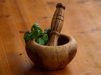 Free grinding basil with mortar and pestle image, public domain appliances CC0 photo.