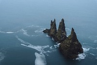 Island with cliff, rocks, caves, free public domain CC0 photo.