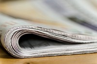 Free folded newspaper on table closeup image, public domain CC0 photo.