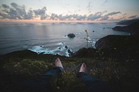 Sitting on cliff facing ocean, free public domain CC0 photo.