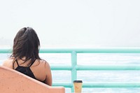 Free woman sitting by the sea photo, public domain travel CC0 image.