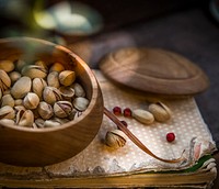 Free pistachio seeds in wooden bowl public domain CC0 photo.
