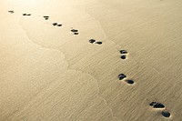 Footsteps on beach, free public domain CC0 image.