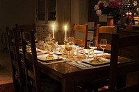 Free candle lit on dining table photo, public domain celebration CC0 image.