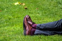 Free legs crossed on grass image, public domain relax CC0 photo.