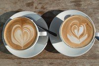 Free coffee heart latte art top view on wooden table photo, public domain beverage CC0 image.