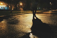 Man walking in dark city, free public domain CC0 image.