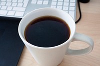 Free black coffee at work photo, public domain beverage CC0 image.