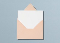 Pastel pink envelope, white card, flat lay design