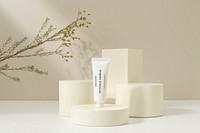 Hand cream tube, beauty product packaging, beige product podiums