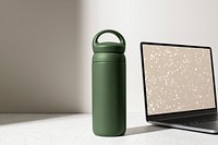 Green thermal bottle, minimal product in aesthetic workspace