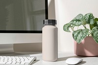 Pink thermal bottle, minimal product in aesthetic workspace