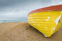Free yellow boat on shore image, public domain CC0 photo.