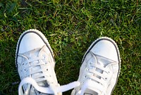 Free white sneakers on grass photo, public domain shoes CC0 image.