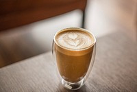 Free coffee with heart latte art on wooden table photo, public domain beverage CC0 image.