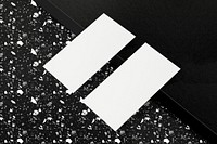 Blank business card on black terrazzo floor 