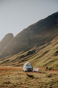 Vintage van aesthetic background, camping in nature, Scottish Highlands