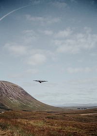 Old military plane over Glencoe Valley, Scotland