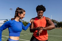 Male and female athletes looking at a fitness tracker data