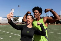 Male and female athletes flexing and taking a selfie