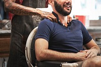 Customer getting shoulder rub in barber shop