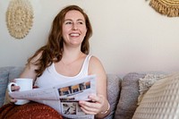 Woman reading newspaper in the morning