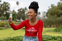 Woman in red tee, having video call, casual wear
