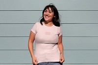 Happy Latina woman wearing a pink tshirt with abstract wave design