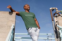 Happy African American man posing, wearing green tee