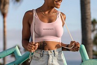 Woman wearing pastel pink top at the Venice beach, modernity text