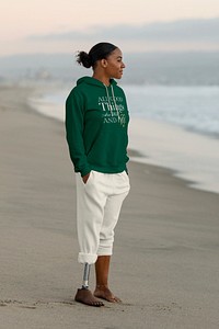 Beautiful amputee woman standing, wearing casual sweatshirts and pants