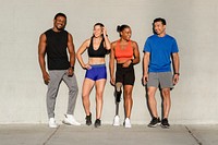 Diverse athletes posing by the wall 