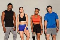 Diverse athletes posing by the wall 