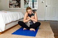 Woman playing with pet dog during exercise session