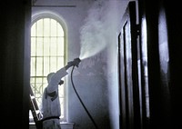 A worker wearing a protective mask and suit. Original image sourced from US Government department: Public Health Image Library, <a href="https://www.rawpixel.com/search/cdc?sort=curated&amp;page=1">Centers for Disease Control and Prevention</a>. Under US law this image is copyright free, please credit the government department whenever you can&rdquo;.