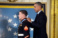 President Barack Obama, right, awards the Medal of Honor to retired U.S. Marine Corps Cpl. William Carpenter during a ceremony at the White House in Washington, D.C., June 19, 2014.