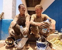 110331-N-SN160-035 DJIBOUTI - (March. 31, 2011) U.S. Navy Petty Officer 3rd Class Caleb Baker and U.S. Navy Constructionman Eric Hofmans, both Seabee constructionmen assigned to Naval Mobile Construction Battalion (NMCB) 74 Detail Horn of Africa (Det, HOA), take a break from pouring a concrete wall around the recently constructed Ecole 5 primary school in Djibouti, March 31.