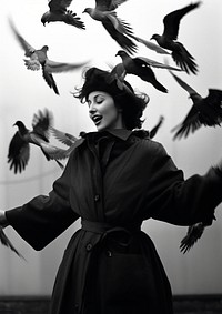 A woman wearing vintage coat playing with birds photography portrait animal. AI generated Image by rawpixel.