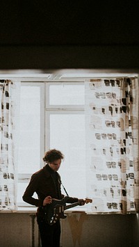 Man playing a guitar in his room mobile phone wallpaper