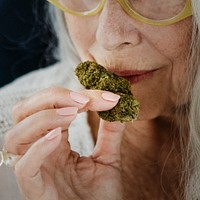 Senior woman smelling a weed